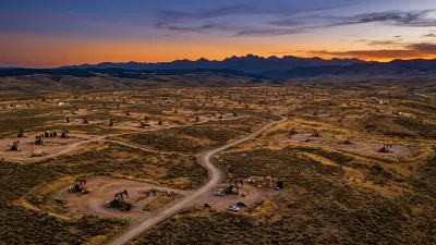 Editorial image: Aerial pumpjack field, wilderness boundary - Trump Administration Opens Federal Wilderness to Oil and Gas Drilling