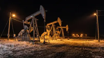 Editorial image: Bakken pumpjacks working at night - Continental Resources Restarts Bakken Drilling as Oil Prices Near $100