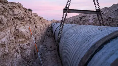 Editorial image: Pipe lowered into desert trench - SNWA's $2.7 Billion Horizon Lateral Pipeline Moves Forward After Federal Approval