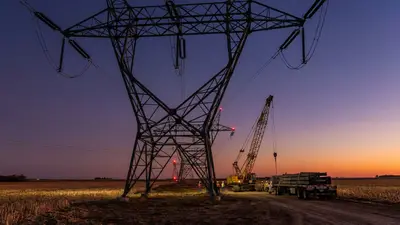 Editorial image: Transmission towers at dusk - PowerOn Midwest Transmission Plan Projects 5,000 Construction Jobs and $2B in Economic Activity