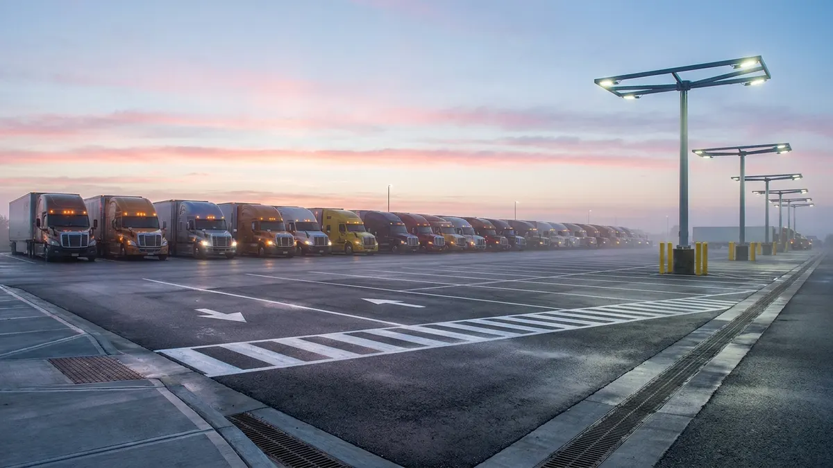 Editorial image: Truck parking lot at dawn - USDOT Launches $627M INFRA Grant Round With $200M Set-Aside for Truck Parking