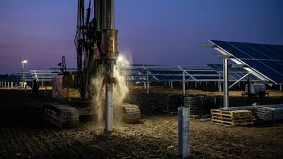 Editorial image: Pile-driving solar racking foundations at dusk - Google Signs PPA for Arkansas Mega Solar Project Built by Moss