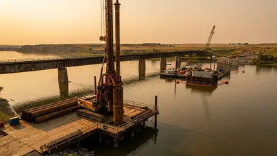 Editorial image: Drilled-shaft rig at river bridge site - Ames Construction Wins $290M South Dakota Bridge Replacement