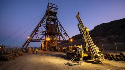 Editorial image: Underground mine shaft headframe at dusk - Resolution Copper Awards $110M in Drilling, Underground Development Contracts