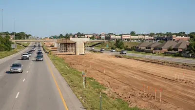 Editorial image: Highway expansion corridor with survey stakes - Tennessee's $9.2B I-24 Toll Lanes Deal Signals Decade of Heavy-Civil Work