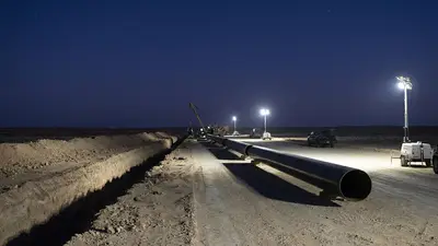 Editorial image: Night pipeline trench staging, new construction - WhiteWater's Solitude Pipeline FID Signals New Permian Buildout Wave