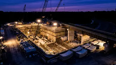 Editorial image: Tunnel launch pit excavation at dusk - Amtrak's $6B Baltimore Tunnel Overhaul Signals Years of Heavy-Civil Work Ahead