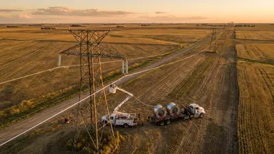 Editorial image: aerial reconductoring work on transmission corridor - DOE's $1.9B Transmission Push Signals Near-Term Work for Line Crews