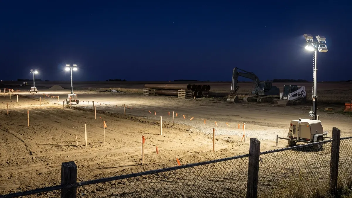 Editorial image: Night groundbreaking, pipe staging, rural site - Enhance Energy Breaks Ground on Canada's Largest Carbon Capture Hub in Alberta