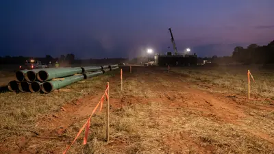 Editorial image: Pipeline staging yard at dusk - Kosciusko Junction Pipeline Clears Federal Permitting, Construction Set for 2027