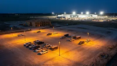 Editorial image: Empty jobsite versus lit-up data center - Texas Construction Firms Face Labor Squeeze as Data Centers Compete for Workers