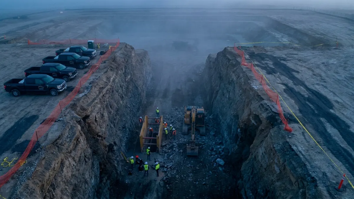 Editorial image: Workers beneath unstable excavation embankment - OSHA Proposes $648K Against Six Contractors at Monroe, NY Excavation